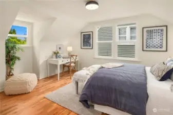 The third of the three bedrooms is also located upstairs and similarly boasts refinished hardwoods, 3 new windows, fresh paint and new lighting.