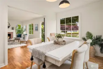 This spacious dining room also features a 9-pane picture window (as well as 2 brand new single hung windows), new fixtures and hardwood floors.