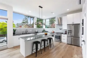Beautifully designed kitchen with a sophisticated palette of tile and Quartz work surfaces. Large center island and breakfast bar, commercial quality gas range and SS appliances.