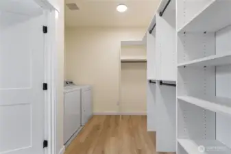Primary walk-in closet with built-ins + washer/dryer