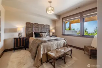 Bedroom downstairs off of lower level family room has wide open views of the beautiful surrounding landscapes.
