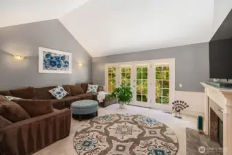 Living room features vaulted ceilings...