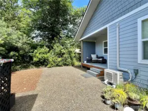 View of the walk-in storage shed, back of   home and Mini Split Heater/ AC unit by the   deck steps