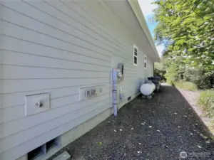 30 AMP Plug and View of the North side of   the home. Propane and convenient utiltiy   connections here