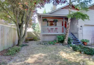 NIce covered porch and side yard in front.