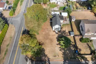 This was the very first home in the neighborhood, standing proudly since 1910. The aerial perspective highlights the wide frontage and established trees that nod to the property’s orchard past. There is still even two producing apple trees.