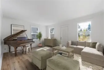 Step into a sun-lit gathering space that reflects the home’s century-old charm. The tall windows and brand new wood floors set the stage for both everyday living and special moments. There’s room here for music, conversation, and the sense of connection that has defined this property since it first anchored the neighborhood in 1910. (Virtually staged)