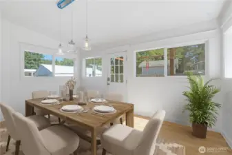 Gather in a bright dining space where sunlight streams through walls of windows, highlighting the craftsmanship of this 1910 home. Whether set for an intimate meal or a lively gathering, this room connects the indoors with the greenery just outside, offering a warm and welcoming backdrop. Easy access to the back deck where you can BBQ.