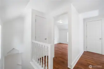 Bright and open, the upper landing is a versatile space that reflects the home’s historic character. The wood flooring has been carried through the upstairs flooring, while the fresh white walls and millwork highlight the timeless design of this early 20th-century home. Look at that lovely accent detail over the stairs.