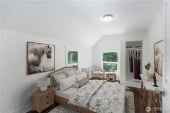 Bright and welcoming, this bedroom captures the apple tree in front from its double windows. The angled ceiling nods to the home’s 1910 architecture, while the layout offers flexible use as a guest room, home office, or cozy retreat.