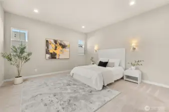 Wake up to soft light and peaceful surroundings in the primary bedroom.