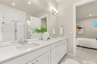 Roomy spa-like bathroom with dual sinks and modern finishes.
