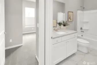 Clean lines and neutral tones create a soothing second bath.