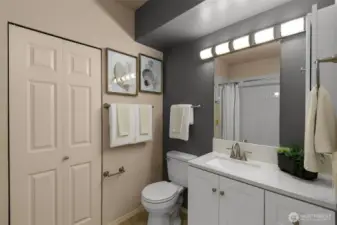 Full bathroom with dual shower heads and, again, more storage.