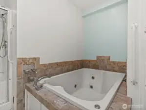 The ensuite bathroom has a jetted soaking tub, perfect for relaxing after a long day.