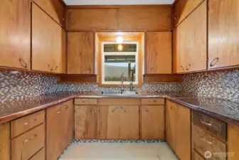 Generous prep space with ample custom copper countertops blends together farmhouse charm and functionality.