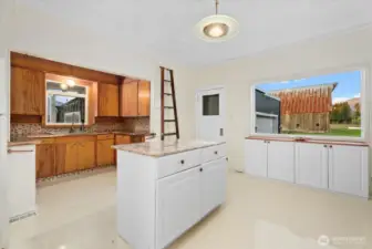 Main level, large bright, flowing kitchen with custom copper accents