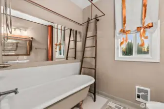 The recently renovated main level bathroom features a custom clawfoot soaking tub.