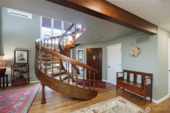 Unique entrance to home w/spiral staircase/finished wood beams and 9"x8'x3/4" oak plank floors on main level.