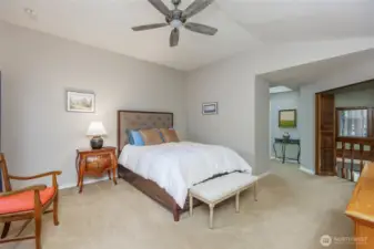 Primary retreat (king sized) w/ceiling fan/balcony to see below & door to private deck.