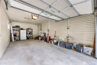 Oversized garage with built-in shelving and ample space for storage or hobbies