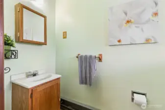 This is the powder room (half bath) located next to the main entry to home. Floor is linoleum.