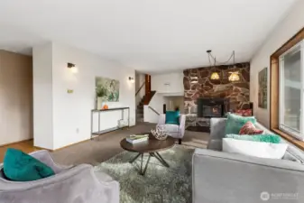 From this view of the living room, to the left leads to the dining room and kitchen. The stairs at center of this photo lead up to the 4 bedrooms.