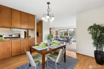 The dining room currently has a table for 4 and there is room for an expanded table to seat several more! The cabinets on the left offer storage for tableware. The dining room connects the kitchen and living room nicely. Laminate floors.