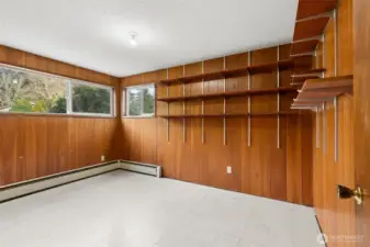 One of two flexible rooms. Adjustable shelves included. The windows view to the back yard. There is also a closet. This space is perfect for office or hobbies; perhaps a future main-floor bedroom!