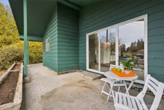 This is the covered patio area that's located just outside the living room with easy sliding glass door access. Wonderful space for relaxing and entertaining. Built-in concrete planters are ready for spring flowers.