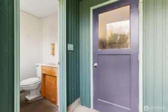 This half bath is great for access when you're too dirty from playing, gardening or working in the shop to go inside. Located off the back patio and next to the garage entrance. Concrete floor.