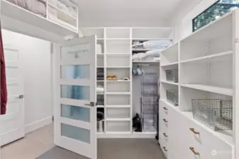 This primary closet is so smart and well thought out. Built in organizers make life so much simpler when you are rushing to find what you need for the day. And who doesn't love a window in their closet?