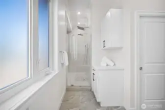 Dual head walk-in shower with towel storage.