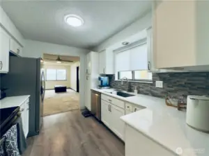 Updated kitchen, white cabinets with pull-out shelvings and pantry. Stainless steel appliances, easy access for entertaining.