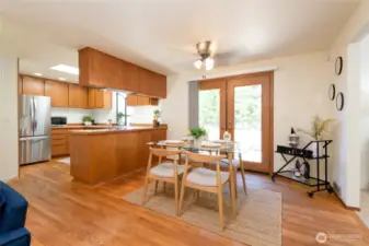 Highlights include a bright oak kitchen with garden window, sun-filled living spaces with hardwood floors and skylights. French doors lead out to your back patio and fenced back yard.