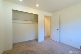 Bedroom #3 with fresh paint and soft neutral carpet underfoot.