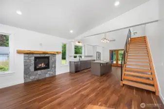 Open floor plan with soaring vaulted ceilings.