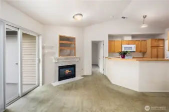 Living & Kitchen View: Open-concept layout connects kitchen and living areas, creating an inviting flow with abundant light and vaulted ceilings.