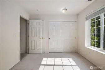 Second Bedroom: Bright second bedroom with large window, double closet, and versatile layout for guests, office, or flex space.