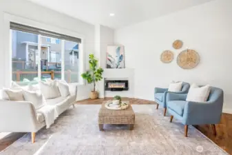 Large living room with large windows and a cozy fireplace