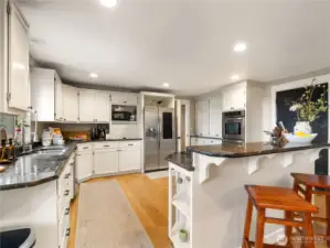 Granit countertops, stainless steel appliances and white kitchen; classic.