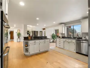 The large kitchen has a view of the open living room and dining room as well as the water view and back yard.