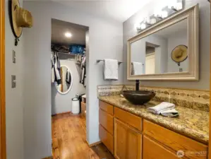 The primary suite full bath on the main level hhas the bathtub/toilet separate from the vanity area.