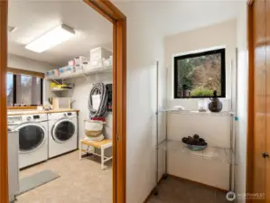 The laundry room is conveniently located next to the kitchen and the walk-in pantry.