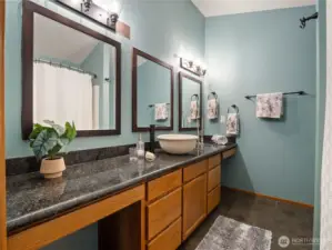 Granite countertops in the primary full bathroom.