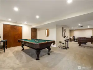The basement has a large game room with room for a pool table, shuffleboard, foosball table and movie area.