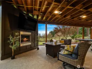 The newly added outdoor fireplace and tv deck has a hot tub and room to install an outdoor kitchen.