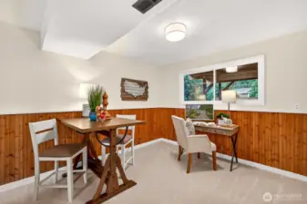 Here’s the bonus flex space that makes everyday living easier, a dedicated spot for a play area, a game table, or a work from home setup with natural light nearby. The soft carpet keeps it comfortable, and the warm wood wainscoting gives the area a finished, intentional look. It is an ideal place to sip coffee, catch up on email, or host friends for cards without taking over the main living areas.