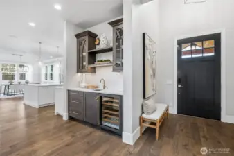 Convenient butler's bar with a beverage fridge and lighting.