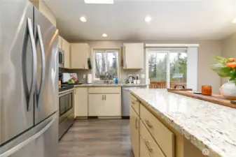 Slab granite counter tops and stainless steel appliances.